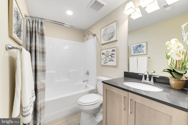 full bathroom featuring tile floors, toilet, vanity, and shower / tub combo with curtain