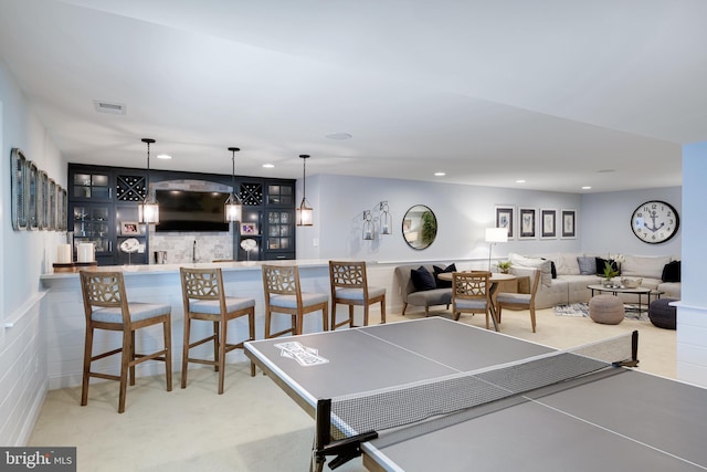 recreation room featuring sink and light carpet