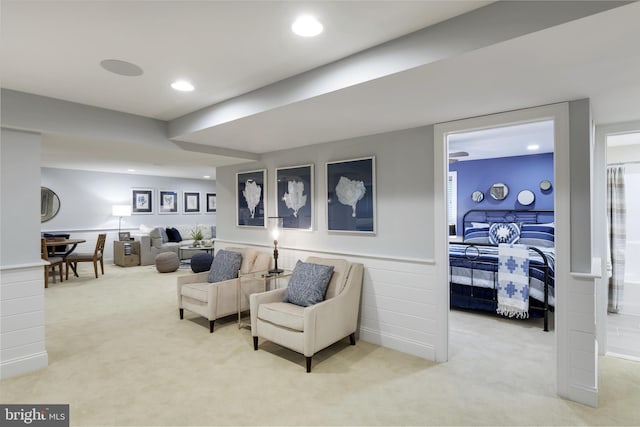 sitting room featuring light carpet