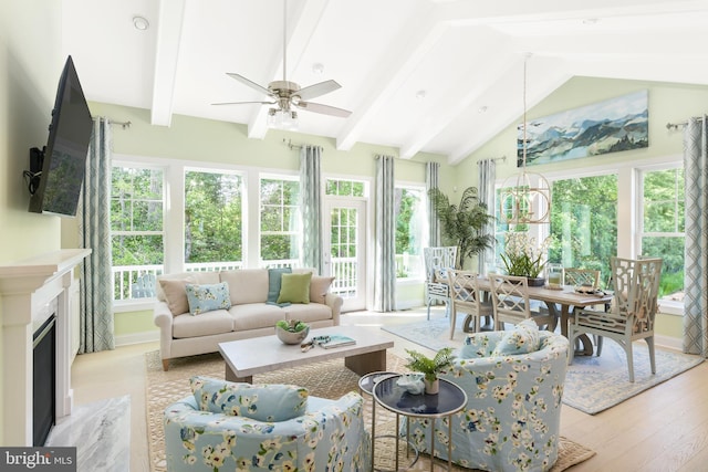 sunroom with lofted ceiling with beams and ceiling fan