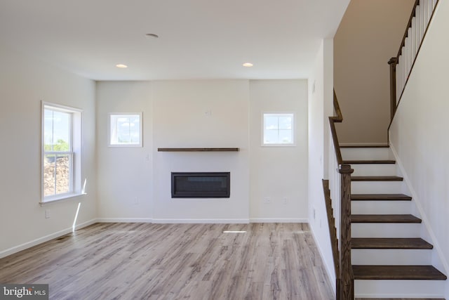 unfurnished living room featuring light wood-type flooring