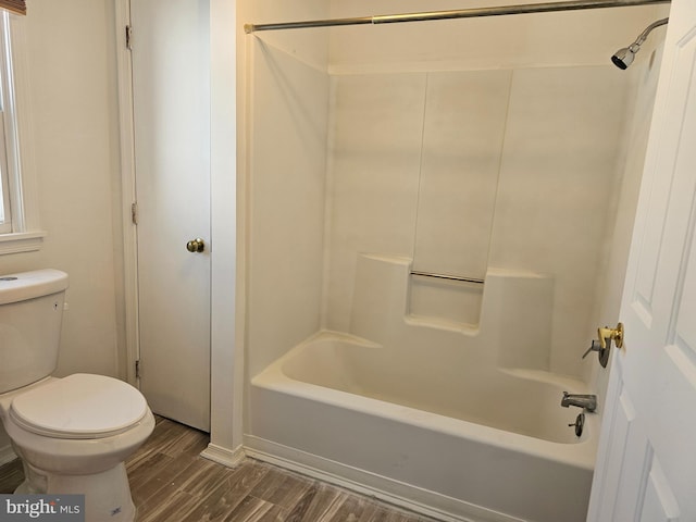 bathroom with shower / tub combination, wood-type flooring, and toilet