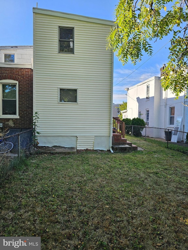 back of house with a lawn