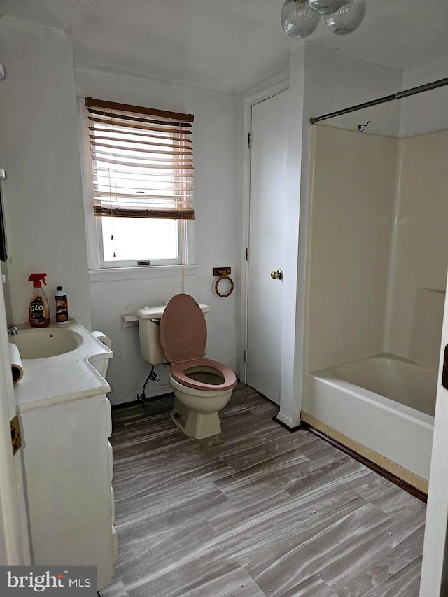 full bathroom featuring vanity, toilet, hardwood / wood-style flooring, and tub / shower combination