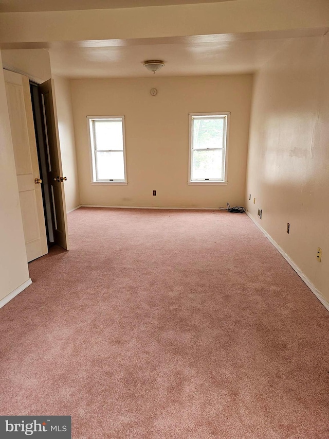 empty room with light colored carpet