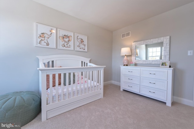 carpeted bedroom with a nursery area