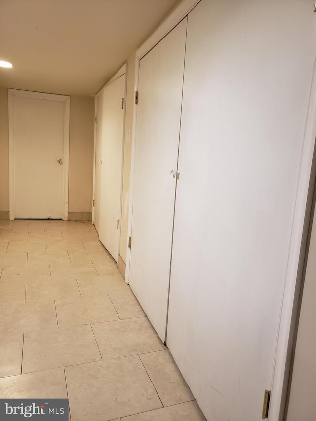 hallway with light tile floors