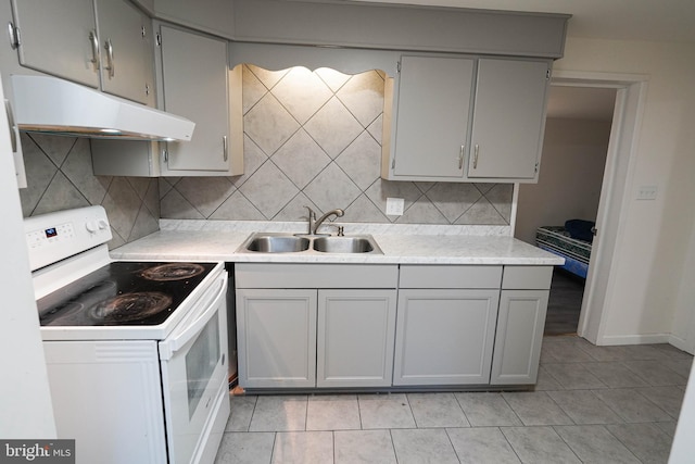 kitchen with gray cabinetry, tasteful backsplash, sink, and white electric stove