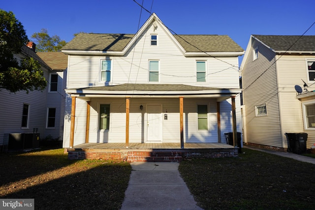 view of front facade featuring a porch and central air condition unit