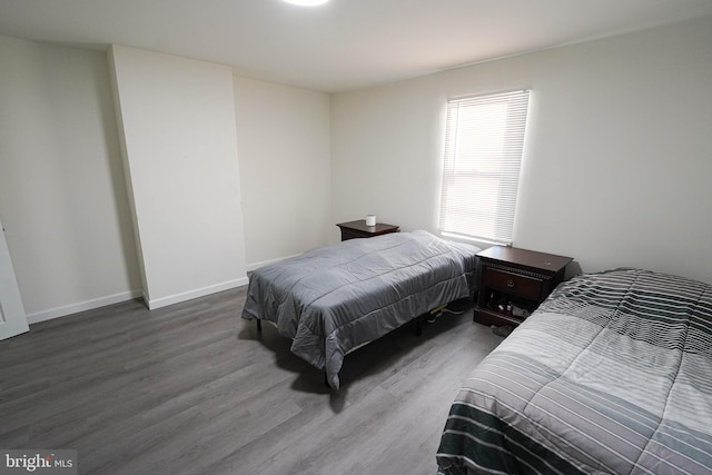 bedroom with dark hardwood / wood-style flooring