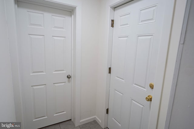 doorway to outside with light tile floors