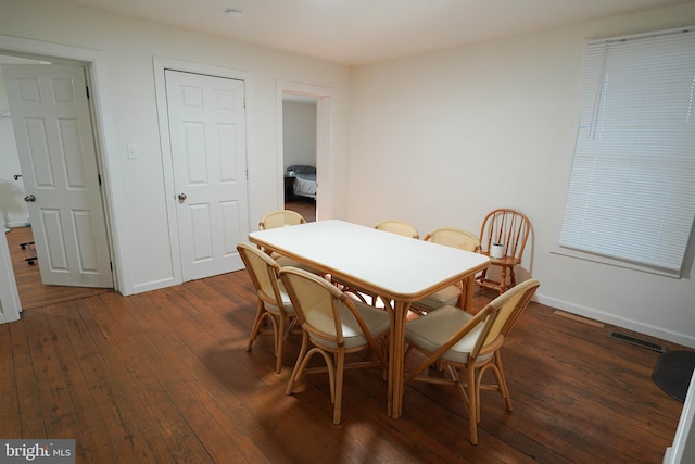 dining room with dark hardwood / wood-style flooring