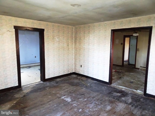 spare room featuring dark hardwood / wood-style flooring