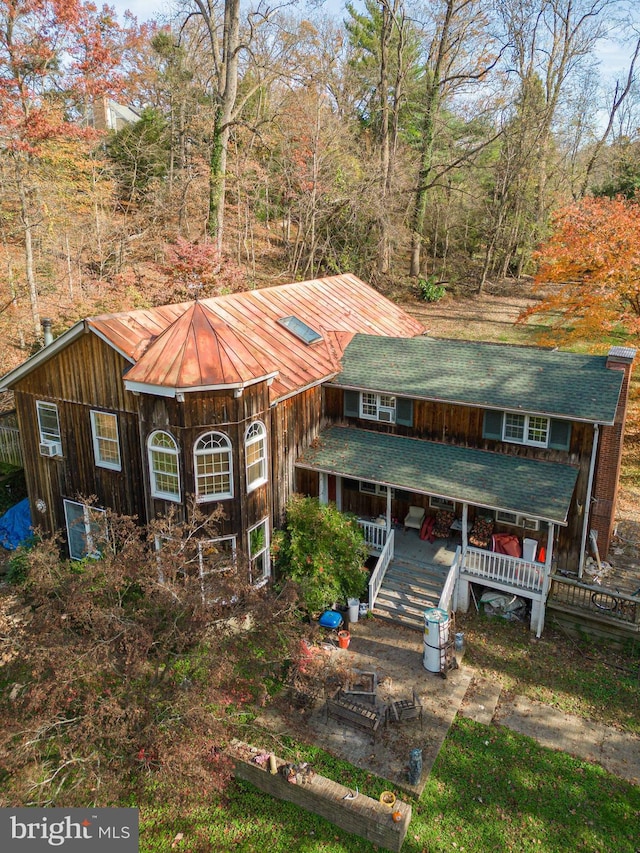 rear view of house featuring a deck