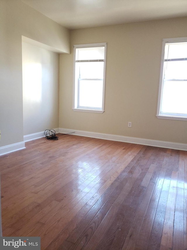 unfurnished room with wood-type flooring