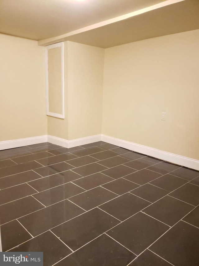 basement featuring dark tile patterned floors