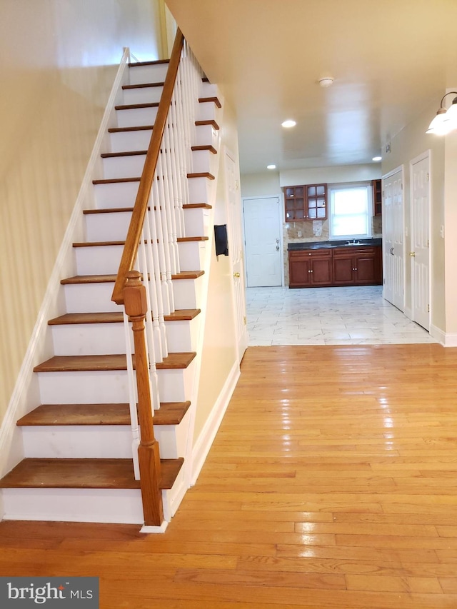 stairs with hardwood / wood-style flooring