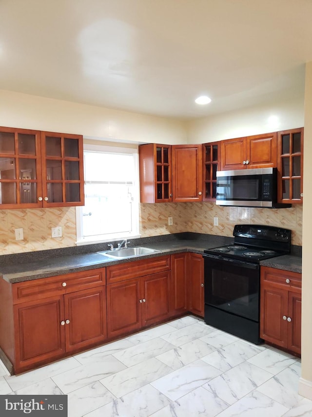 kitchen with black electric range oven, tasteful backsplash, and sink