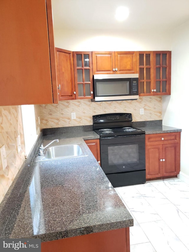 kitchen featuring decorative backsplash, black range with electric cooktop, and sink