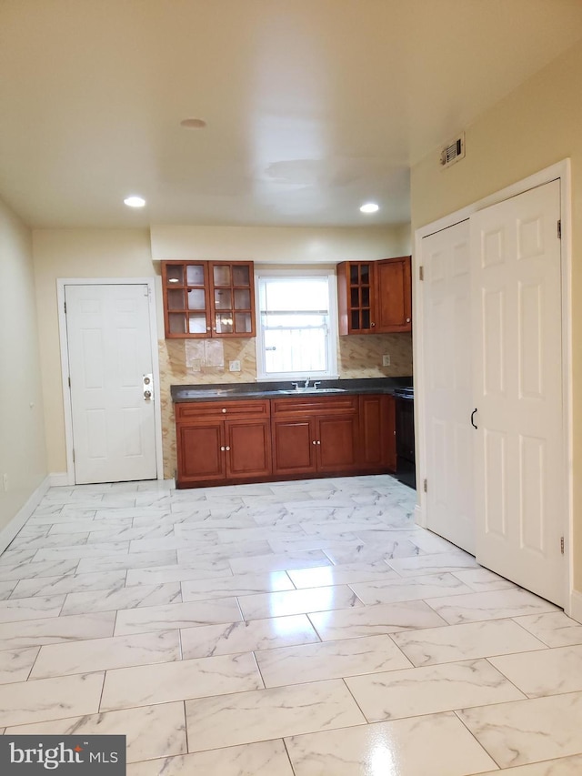2615 N 12th St, Philadelphia, PA 19133 - kitchen featuring marble finish floor, dark countertops, recessed lighting, and decorative backsplash