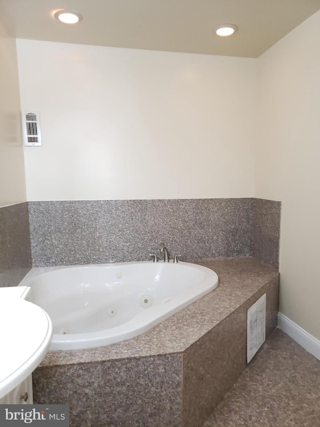 bathroom with tiled bath