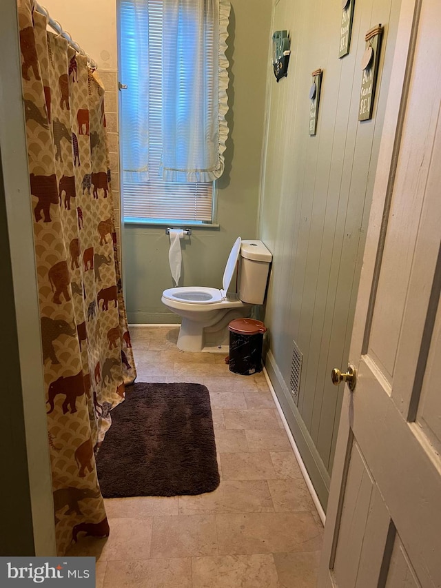 bathroom with tile flooring and toilet