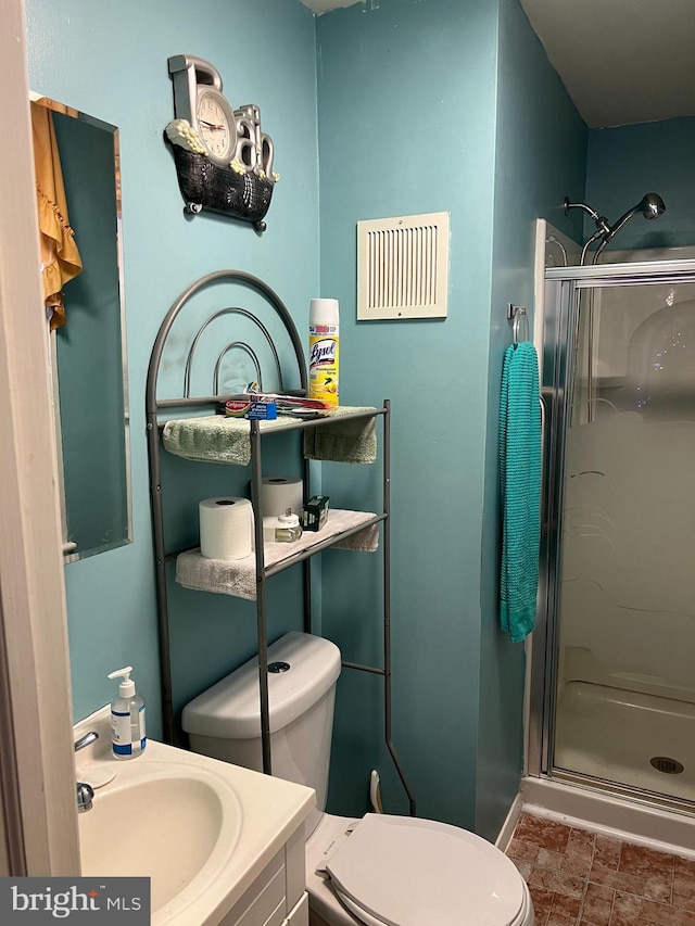 bathroom featuring toilet, large vanity, tile floors, and walk in shower