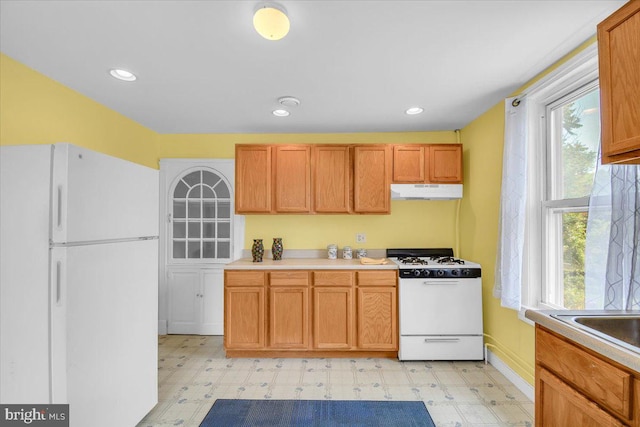 kitchen featuring white appliances and light tile floors