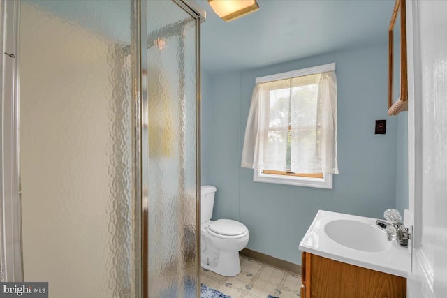 bathroom featuring a shower with shower door, tile flooring, toilet, and vanity