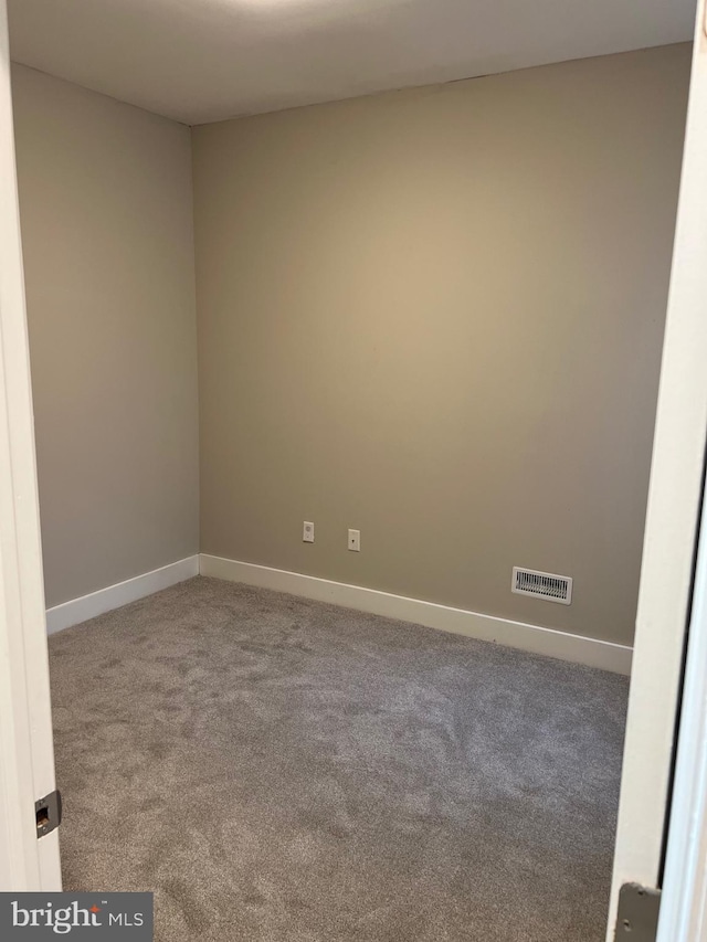 empty room featuring light colored carpet