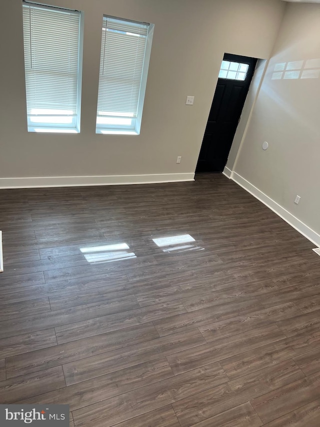 empty room featuring dark hardwood / wood-style flooring