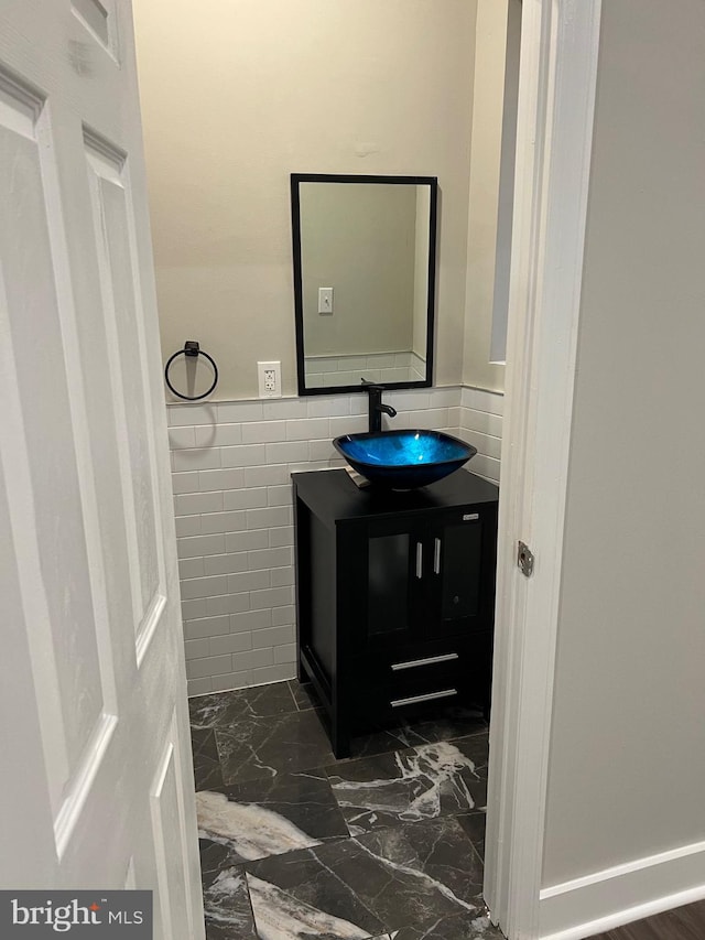 bathroom with tile walls, tile floors, and vanity