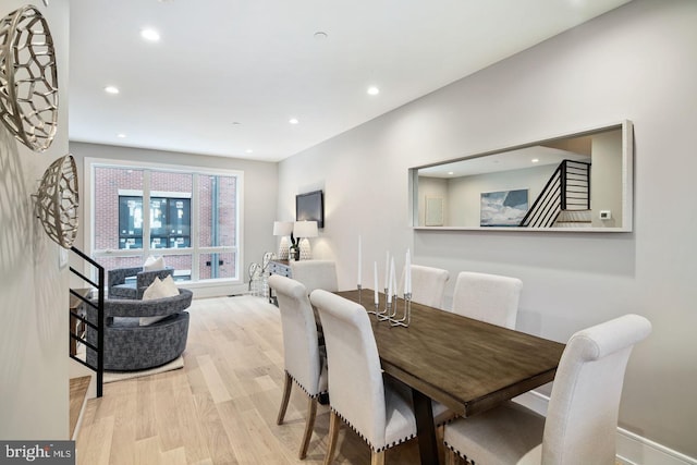 dining space with light wood-type flooring