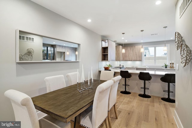 dining space featuring light wood-type flooring