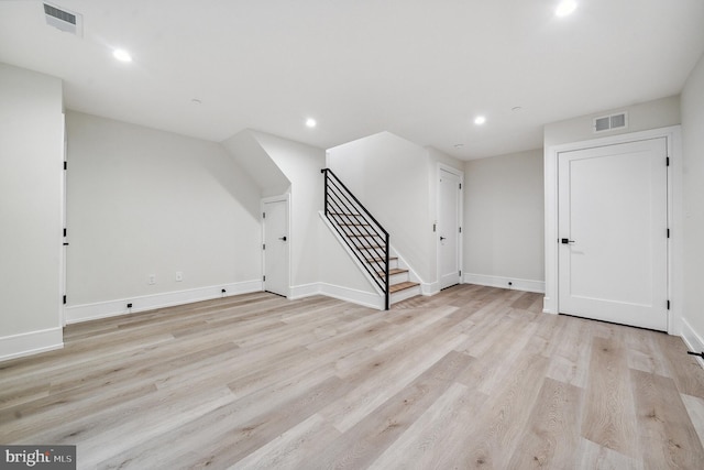 additional living space featuring light wood-type flooring