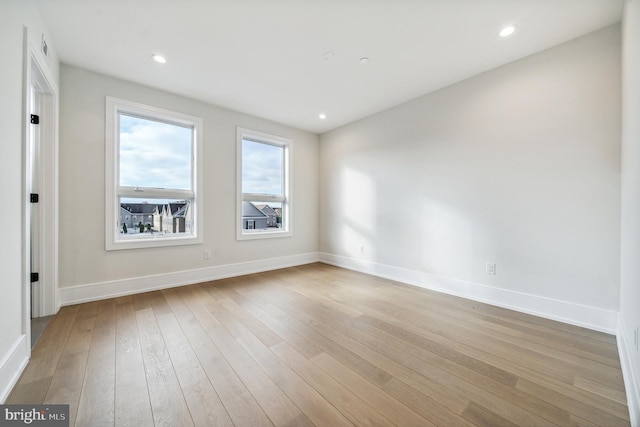 spare room with light hardwood / wood-style flooring