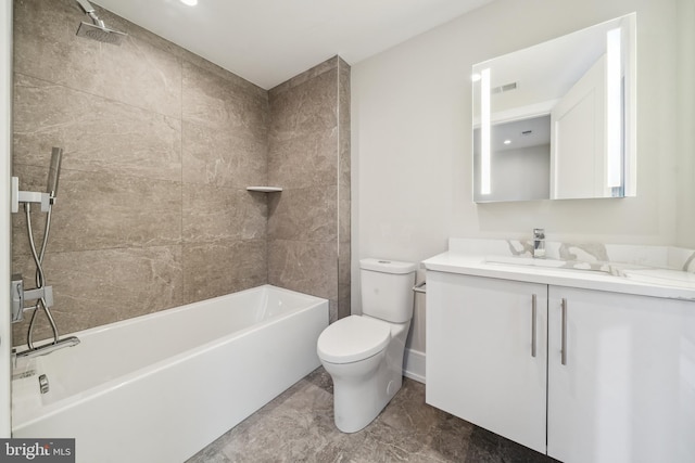 full bathroom featuring toilet, tile floors, tiled shower / bath combo, and vanity