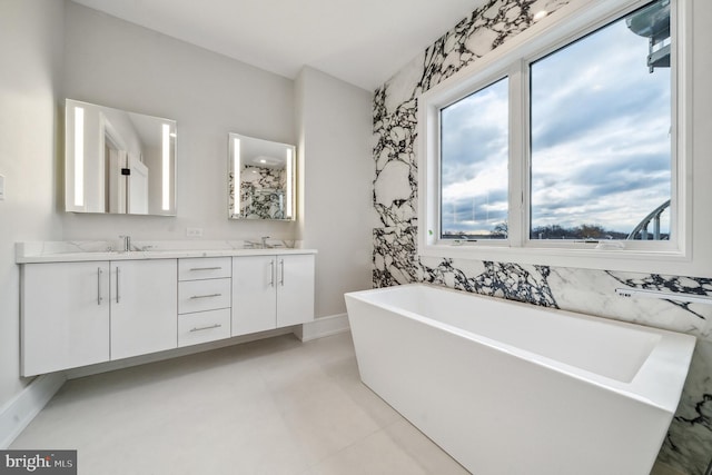 bathroom featuring tile floors, a washtub, and double vanity