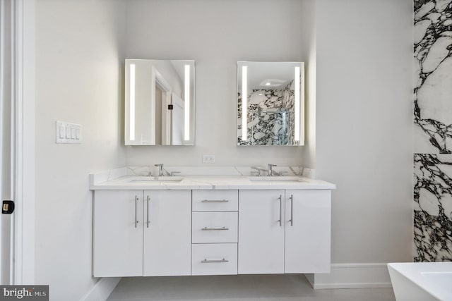 bathroom with tile flooring, dual sinks, and vanity with extensive cabinet space