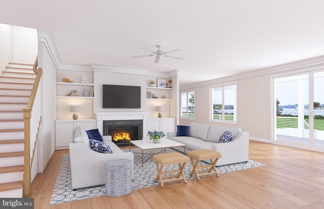 living room with built in features, ceiling fan, crown molding, and light wood-type flooring