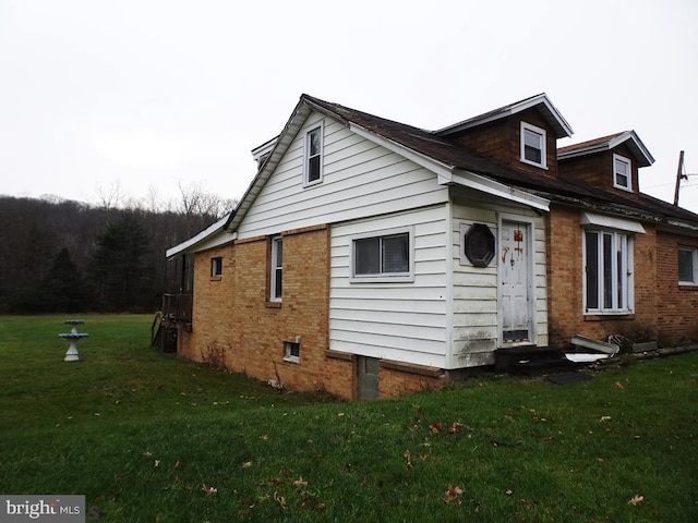 view of home's exterior with a lawn