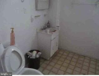 bathroom with sink, tile flooring, and toilet