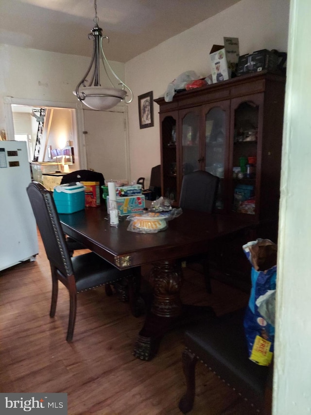 dining area with dark hardwood / wood-style flooring