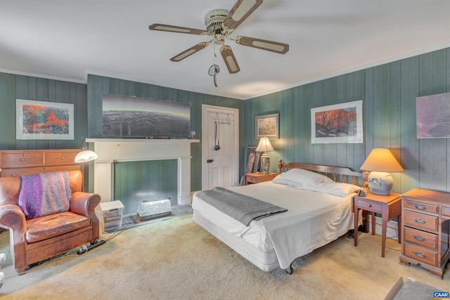 bedroom featuring light carpet, wooden walls, ornamental molding, and ceiling fan