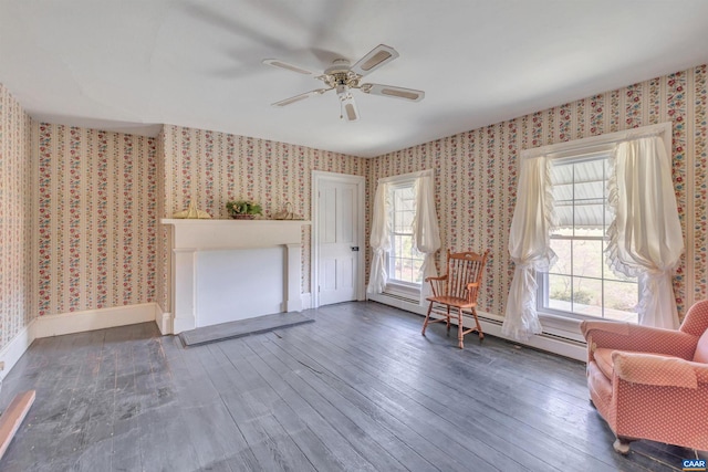 unfurnished room featuring dark hardwood / wood-style flooring, ceiling fan, and a baseboard radiator