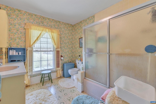 full bathroom featuring tile floors, toilet, vanity, and shower / bath combination with glass door