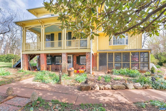 view of front of house featuring a patio and a sunroom