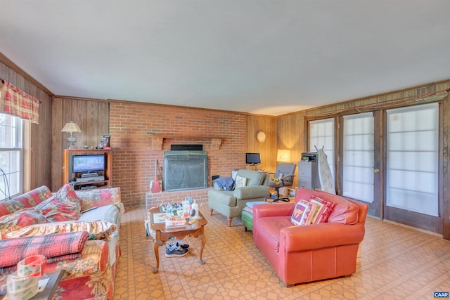 living room with brick wall, wooden walls, and a fireplace