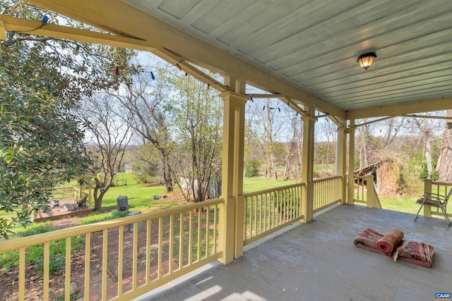 wooden terrace featuring a lawn