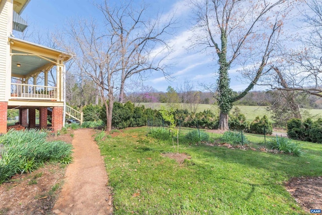 view of yard with a rural view